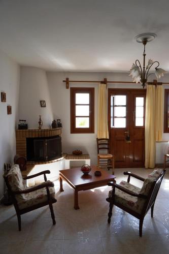 a living room with a table and two chairs at Katiana's House in Aliki