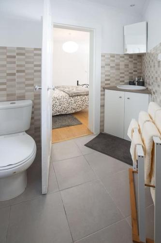 a bathroom with a toilet and a sink and a tub at Dom Pipas Houses - Batista & Marcelino Lda in Sintra