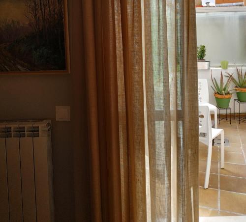 een raam met gordijnen in de woonkamer bij El Bordon in Arguedas