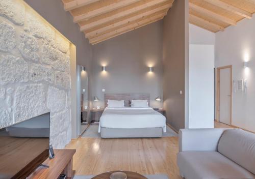 a large bedroom with a bed and a fireplace at Oporto Street Sá de Noronha in Porto