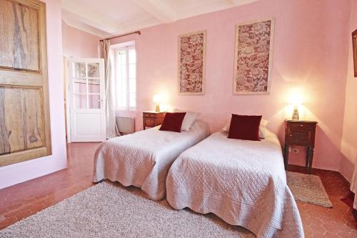 LaurisにあるDemeure d'hôtes la carraireのピンクの壁のドミトリールーム ベッド2台