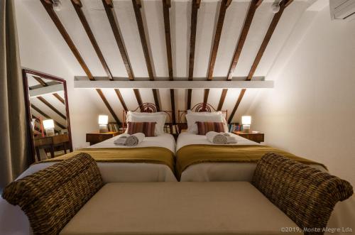 two beds sitting next to each other in a bedroom at Casa do Tamariz, XIX century Beach House in Estoril