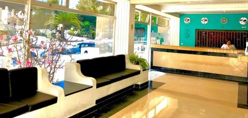 a lobby with couches in front of a store at Albufeira Jardim by Umbral in Albufeira