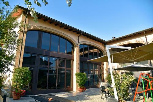 an office building with large windows and an umbrella at Agriturismo Argaland in Parma