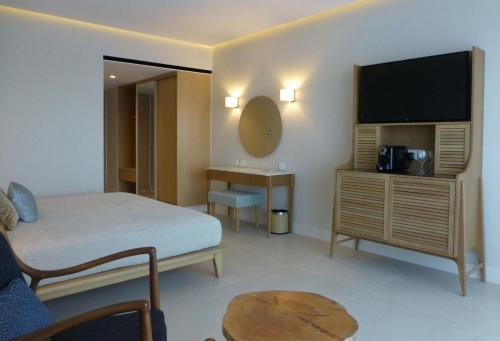 a hotel room with a bed and a television at Sunrise Jade - Adults Only in Protaras