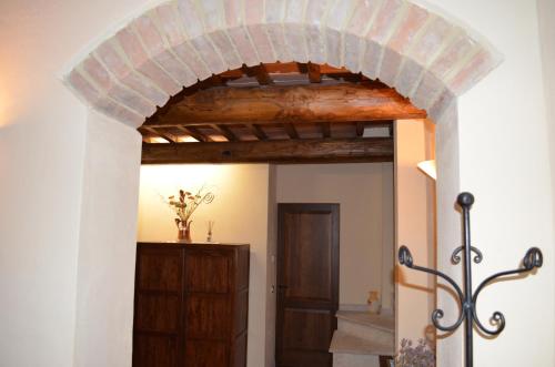 an archway in a room with a wooden door at Palazzo Alle Mura in Staggia