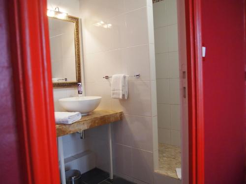 a bathroom with a sink and a mirror at Hotel Colbert in Tours