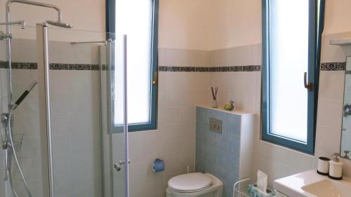 a bathroom with a shower and a toilet and a sink at ARTSEA Studio Apartment with sea view in ‘En Hod