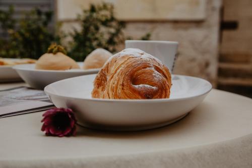 a white bowl with a pastry in it on a table at L'IMPERATORE Relax & Charme in Altamura