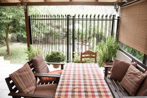 a patio with a table and chairs and a fence at Holiday Zigos in Igoumenitsa