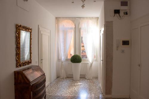 a hallway with a window and a plant in a vase at Porta Orientalis Venice in Venice