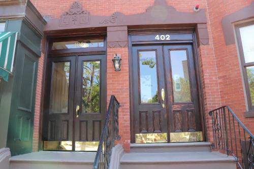 a front door of a brick building at Charming Studio in Boston Brownstone, C.Ave#5 in Boston
