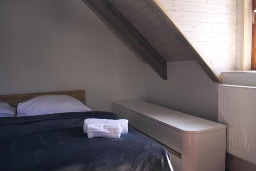a bedroom with a bed and a stair case at Chata Diana in Vítkovice
