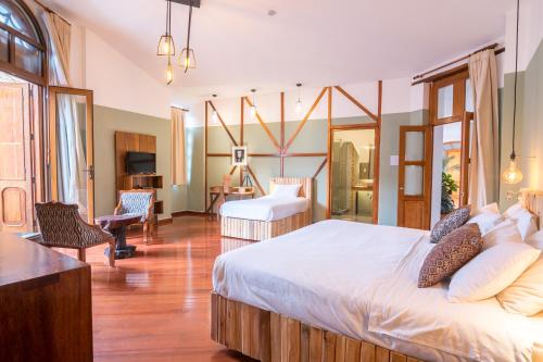 a bedroom with a large bed and a living room at Viajero Quito Hostel in Quito