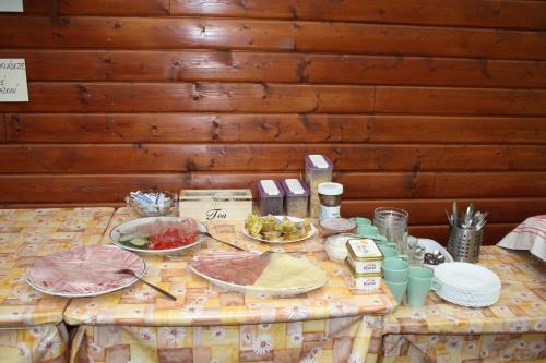 a table with plates of food on it at Letní rekreační středisko Schiffler Miroslav in Samopše