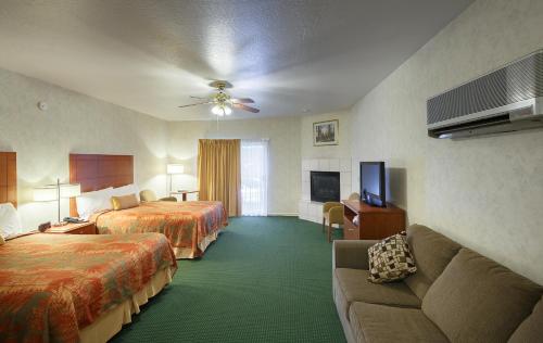 a hotel room with two beds and a couch at Miners Inn in Mariposa