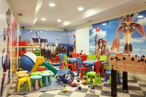 a childrens play room with colorful chairs and tables at Hotel Baita Montana in Livigno