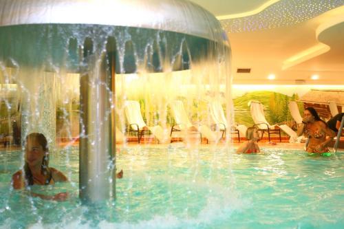 a group of people in the water in a pool at Hotel Baita Montana in Livigno