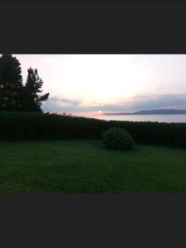 a field of grass with the sunset in the background at Sea View Chalet Kilsallagh Westport Co Mayo in Kilsallagh