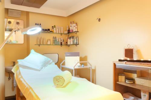 a hospital room with a bed and a mirror at Hotel Baita Montana in Livigno