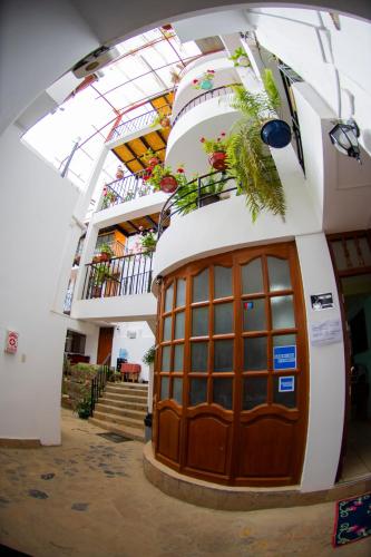 a building with a door with plants on it at La Casa de Los Balcones in Chachapoyas