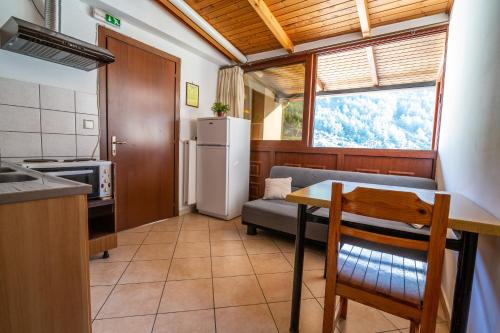 a kitchen and dining room with a table and a couch at Holiday Zigos in Igoumenitsa