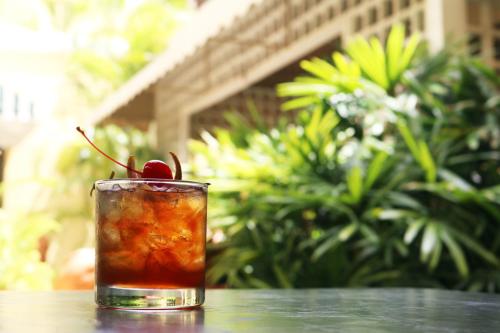 a drink sitting on a table with a cherry on it at Hotel El Convento in San Juan