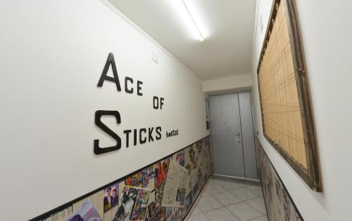 
a wall with graffiti on it in front of a building at Ace of Sticks in Naples
