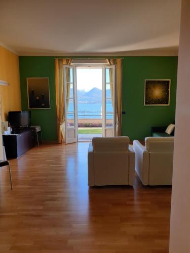 a living room with a view of the ocean at Hotel Residence La Luna Nel Porto in Stresa
