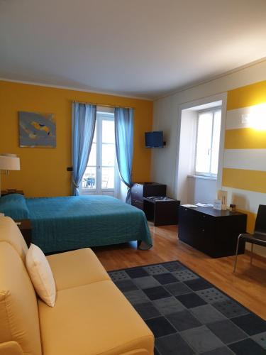 a hotel room with a bed and a couch at Hotel Residence La Luna Nel Porto in Stresa