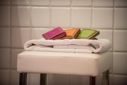 a pile of books sitting on top of towels at Hotel Stella Maris in Villasimius