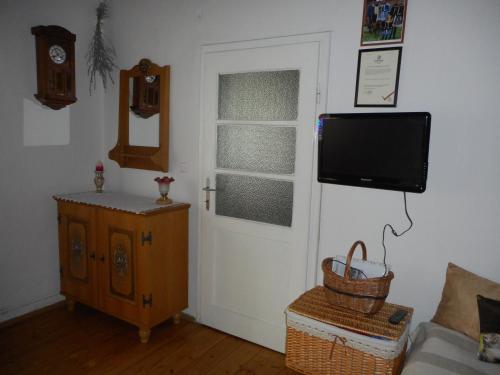 a living room with a door with a tv on the wall at Slovácká chalupa in Ratíškovice