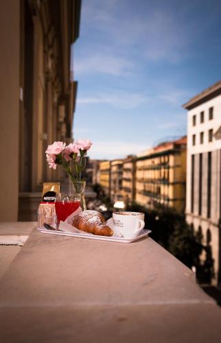 a plate of food on a table with a view of a city at B&B Depretis19 in Naples