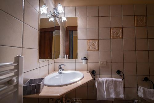 La salle de bains est pourvue d'un lavabo et d'un miroir. dans l'établissement Agriturismo Country Casale Rufo, à Sonnino