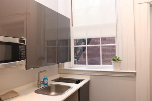 a kitchen with a sink and a window at Charming & Stylish Studio on Beacon Hill #3 in Boston