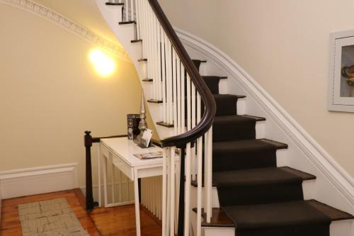 a stairwell with a black and white staircase with a desk at Charming & Stylish Studio on Beacon Hill #3 in Boston