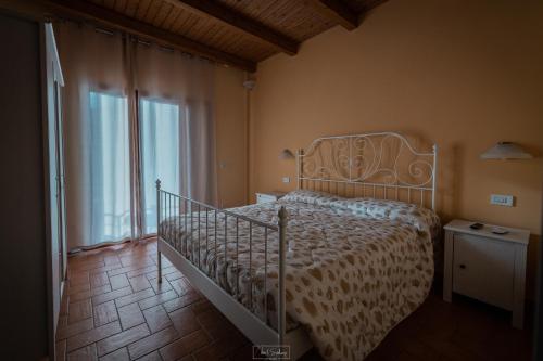 a bedroom with a bed and a large window at Agriturismo Country Casale Rufo in Sonnino