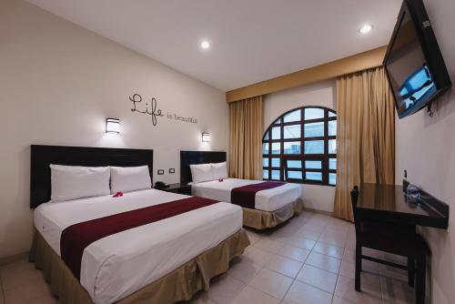 Säng eller sängar i ett rum på Hotel Colonial de Merida