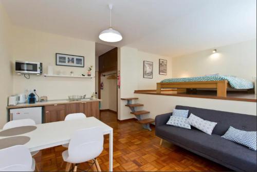a living room with a couch and a table and a kitchen at Studio 312 - With Free Parking in Porto