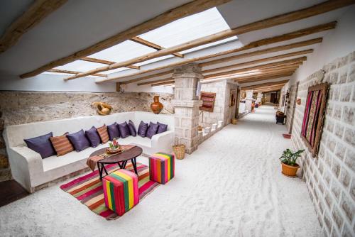 a living room with a couch and a table at Hotel de Sal Luna Salada in Colchani