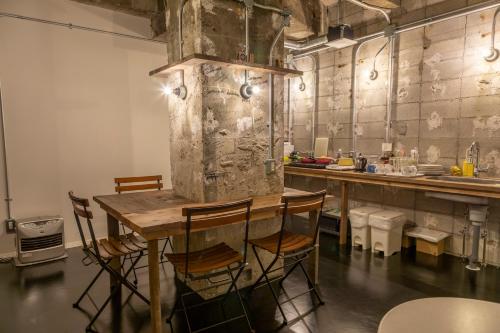 a kitchen with a table and chairs in a room at Midnight Rockers in Kanazawa