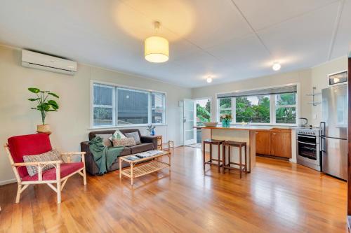 a living room with a couch and a table at Sunny & Cozy Home near Western Springs in Auckland