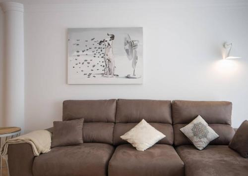 a brown couch in a living room with a picture on the wall at Chez Vous in Lorca