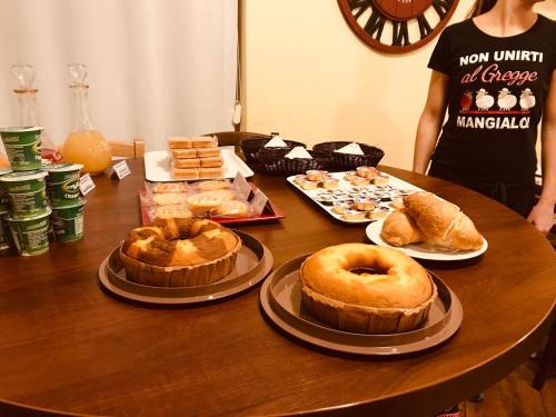 a table topped with different types of cakes and pastries at Rosso Di Sera in Citta' Sant'Angelo