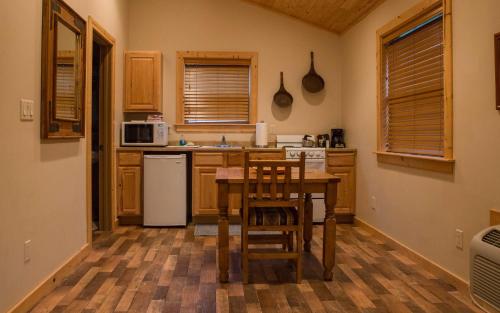 a kitchen with a table and chairs in it at Castle Valley Inn in Moab