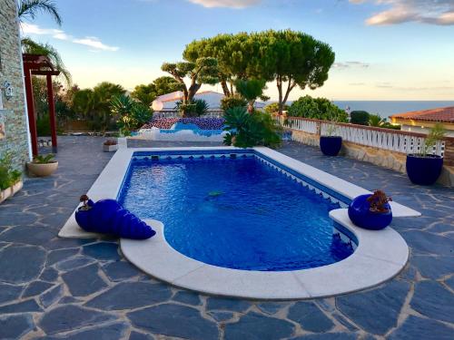 a swimming pool with blue inflatables on a patio at VILLA MIRAMAR in Peñíscola