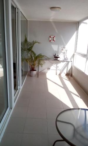 a white room with a table and a window at Pacific Blue in Concón