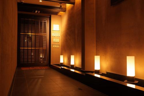 a hallway with three lights on the wall at Hotel Kuu Kyoto in Kyoto