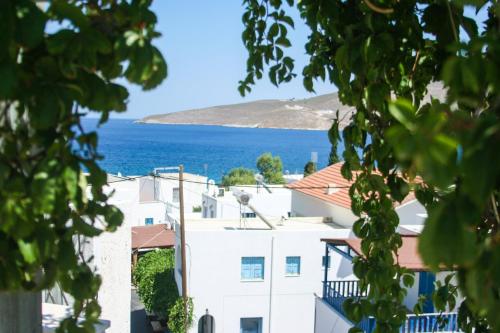 a white building with the ocean in the background at George Apartments in Livadia