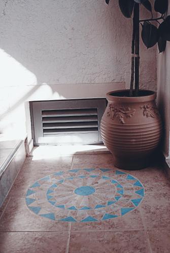 a vase sitting on the floor next to a vase at George Apartments in Livadia